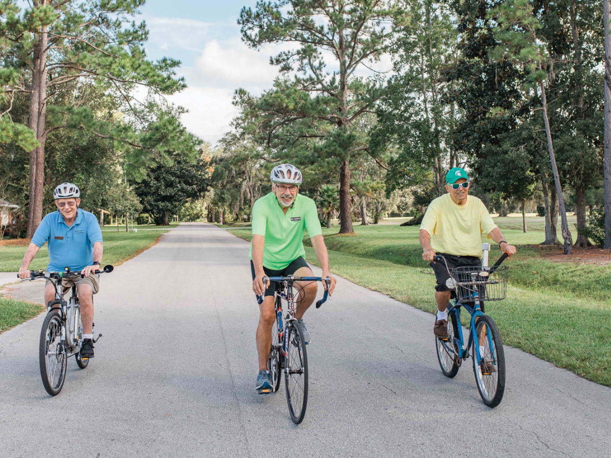 guys riding on bicycles on streets of Penney Retirement Community