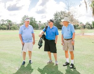 Trio palying golf at Penney Retirement Community
